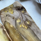 Botanical Eucalypt Socks - Melo Handmades - Botanical socks hand-dyed with eucalyptus leaves in soft gold, brown, and green tones, laid flat on white linen.